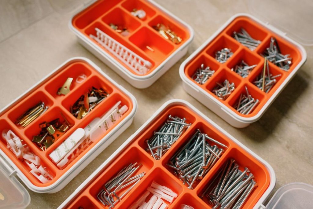 Screws and anchors sorted in orange boxes