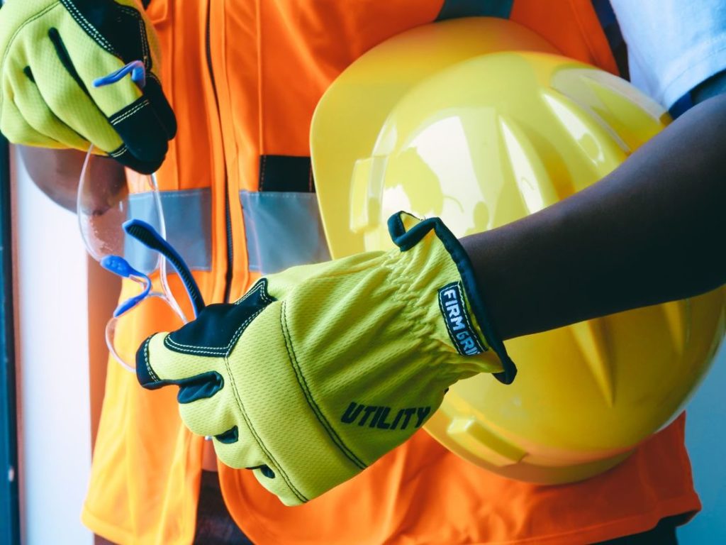 High-visibility work gloves and a hard hat