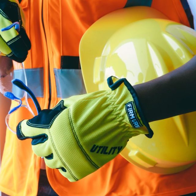 High-visibility work gloves and a hard hat